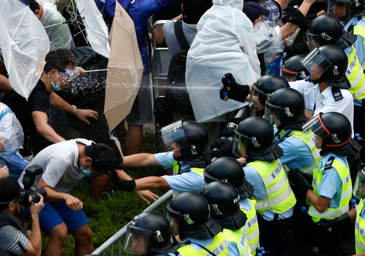 Riot police use pepper spray as they clash with pro-democracy protesters in Hong Kong in September 2014. <a href="https://www.cnn.com/interactive/2014/09/world/scenes-hong-kong-protests/" target="_blank">The student-led unrest</a> was sparked by China's insistence that it be allowed to vet candidates for a 2017 election in Hong Kong — even though residents had been promised they would be able to freely elect their leaders.