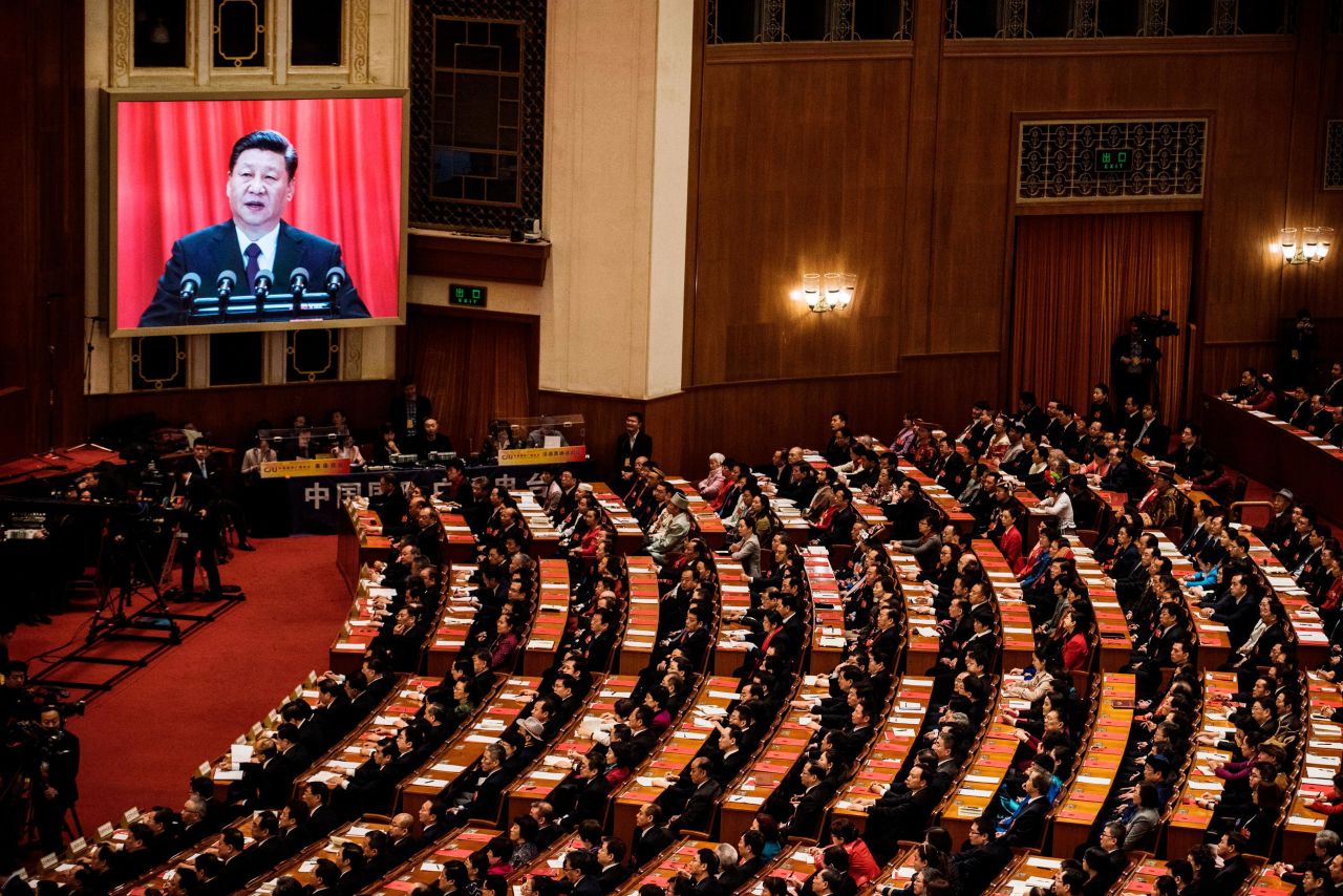 Delegates listen to a speech by Xi Jinping during the closing session of the National People's Congress in March 2018. <a href="https://www.cnn.com/2018/03/11/asia/china-presidential-term-limits-intl/index.html" target="_blank">The country's constitution was changed to abolish term limits that year,</a> paving the way for Xi to stay in power indefinitely.