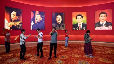 People take pictures in front of portraits of Chinese leaders during an exhibition in Beijing in September 2019. The leaders on the wall, from left, are Mao Zedong, Deng Xiaoping, Jiang Zemin, Hu Jintao and Xi Jinping.