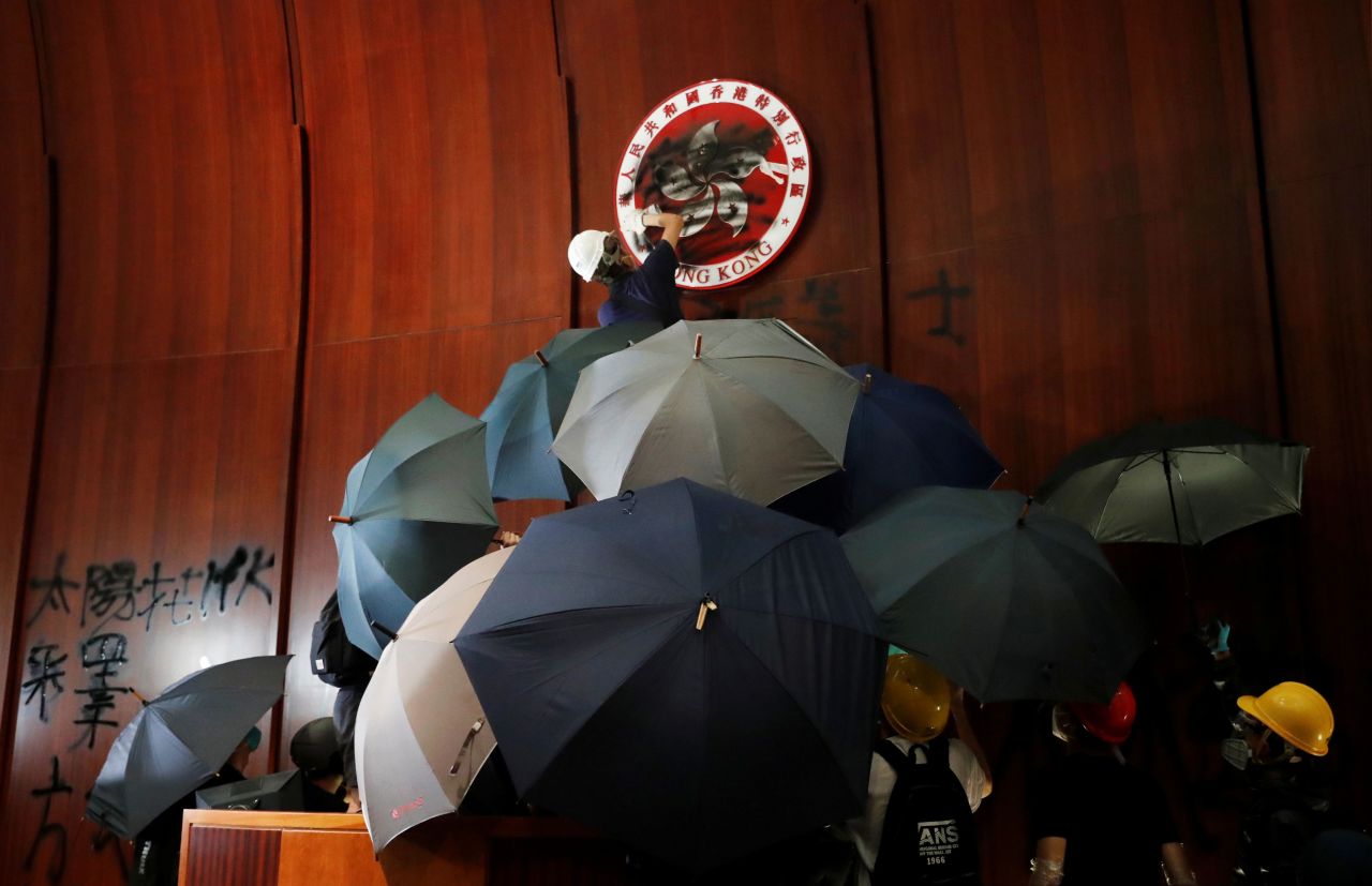 A demonstrator sprays paint inside a chamber at Hong Kong's Legislative Council building after protesters forced their way in on July 1, 2019. Thousands of protesters marched to mark the 22nd anniversary of the former colony's handover from Britain to China.