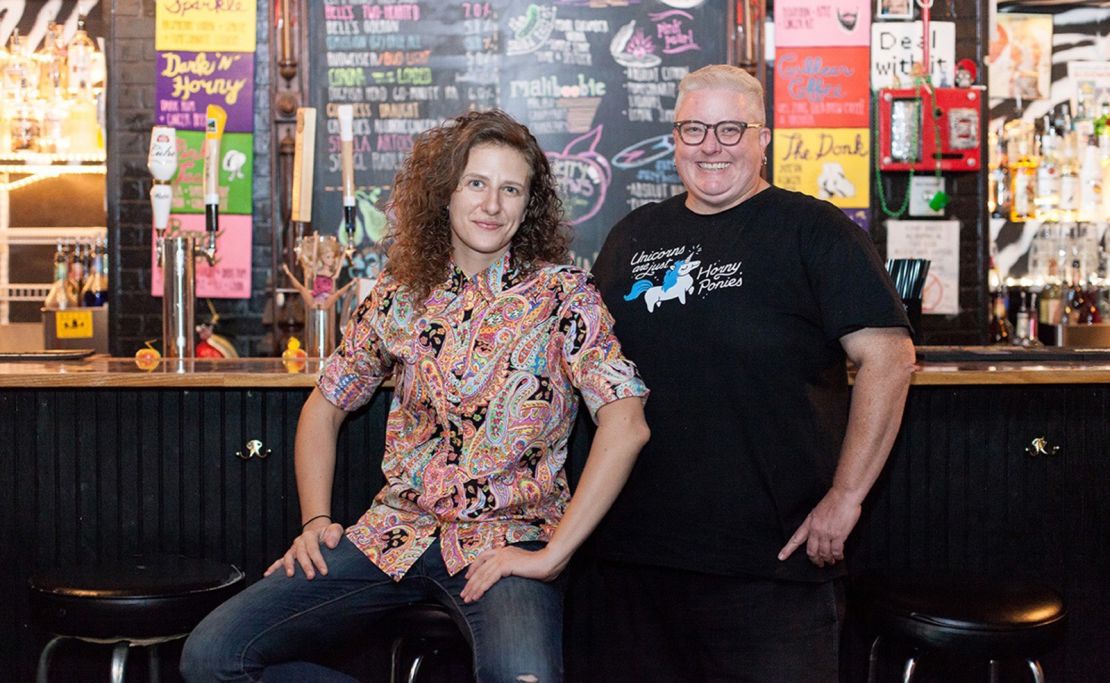 Nicci Boroski and Smoove Gardner, owners of The Back Door located in Bloomington, Indiana. To preserve the long-term future of their bar and entertainment space, Gardner purchased The Back Door's building. Many LGBTQ+ establishments, especially lesbian bars, have closed as a result of urban renewal and gentrification.