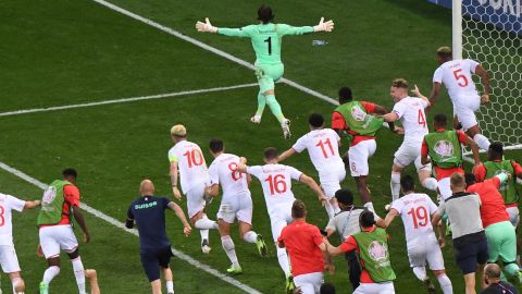 Switzerland goalkeeper Yann Sommer wheels away in celebration after saving Kylian Mbappe's penalty.