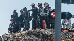 Search and Rescue teams look for possible survivors in the partially collapsed  Champlain Towers South condo building Monday.