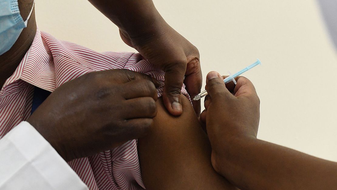 A Kenyan health worker receives a dose of the Oxford/AstraZeneca vaccine in Nairobi on March 5, 2021.