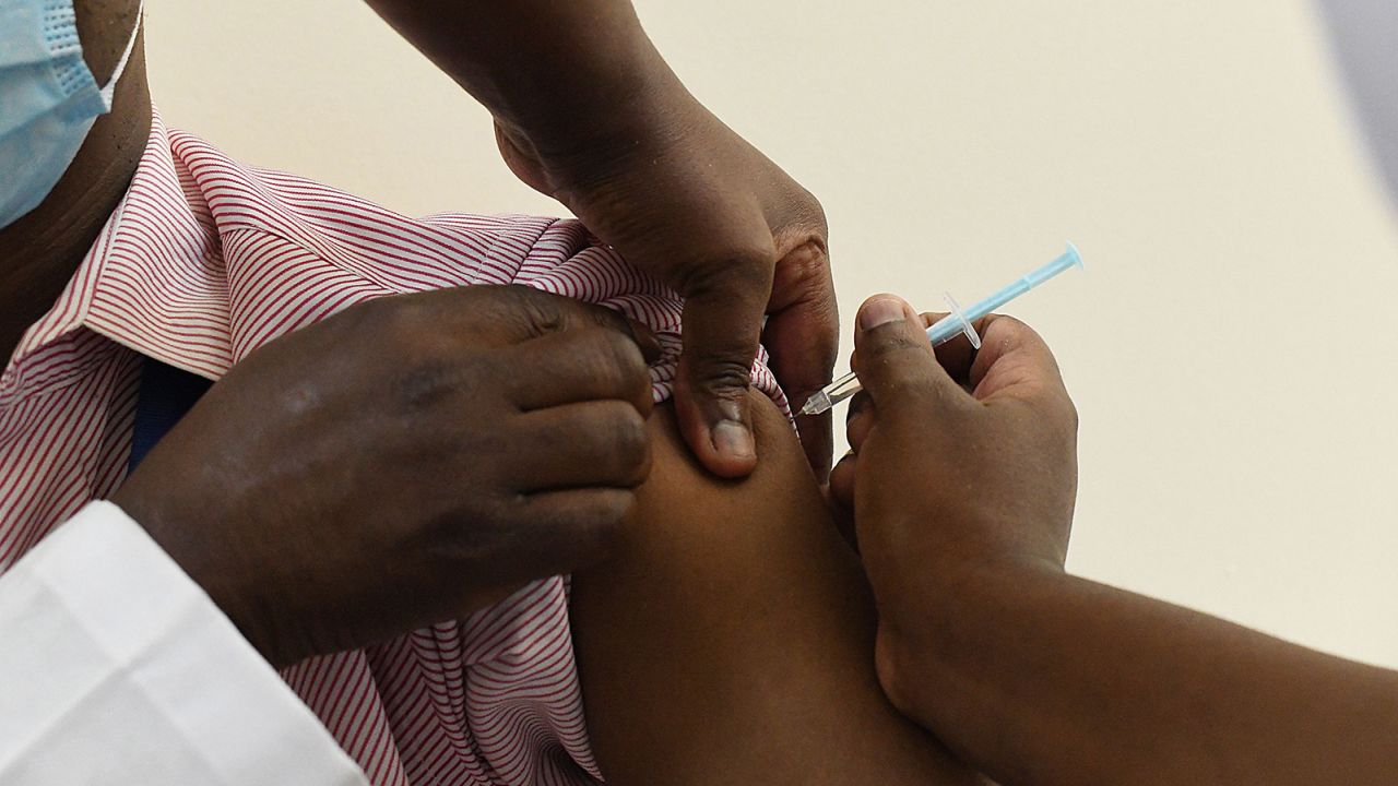 A Kenyan health worker receives a dose of the Oxford/AstraZeneca vaccine in Nairobi on March 5, 2021. 