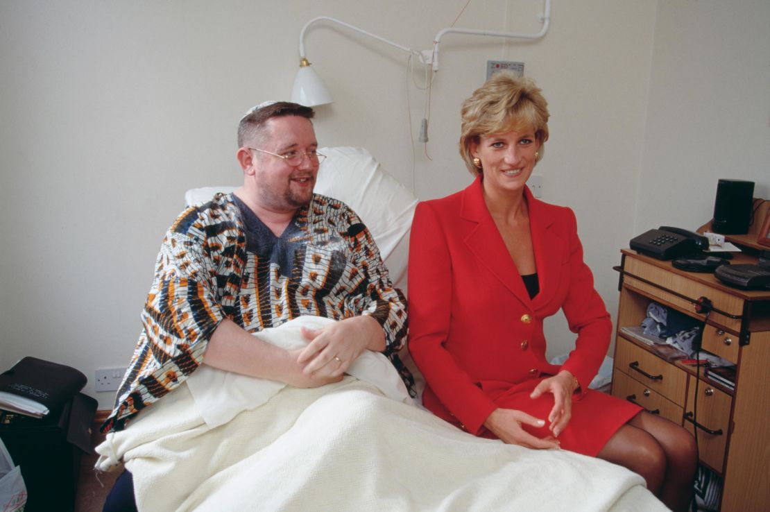 Princess Diana wearing a red Catherine Walker suit during a 1996 visit to a center for people affected by HIV and AIDS. 