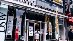 A shopper enters a Designer Shoe Warehouse (DSW) store in the Herald Square area of New York, U.S., on Thursday, Aug. 6, 2020. 