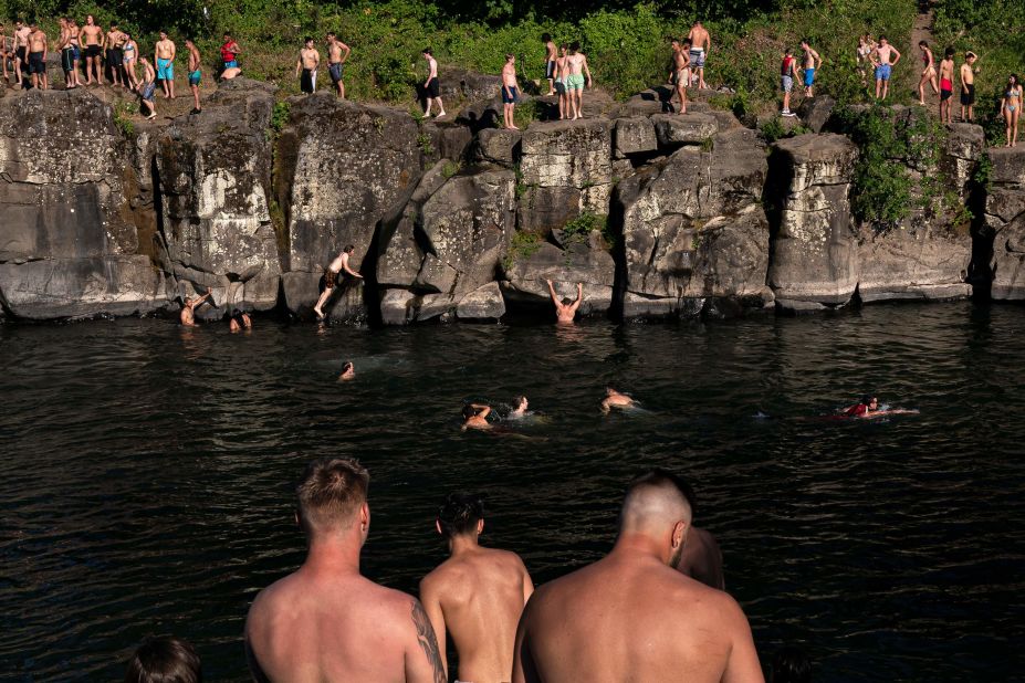 Cliff divers line up along the Clackamas River at Portland's High Rocks Park on Sunday.