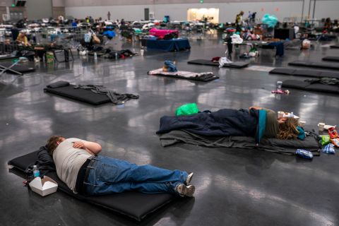 People rest at a cooling center that was set up at the Oregon Convention Center in Portland on Sunday.