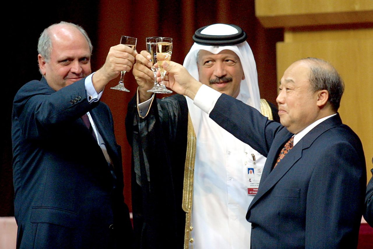 From left, Mike Moore, director-general of the World Trade Organization; Yousef Hussain Kamal Al Emadi, Qatar's economy and finance minister; and Shi Guangsheng, China's minister of foreign trade and economic cooperation, share a toast as China entered the World Trade Organization in November 2001.