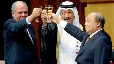 From left, Mike Moore, director-general of the World Trade Organization; Yousef Hussain Kamal Al Emadi, Qatar's economy and finance minister; and Shi Guangsheng, China's minister of foreign trade and economic cooperation, share a toast as China entered the World Trade Organization in November 2001.