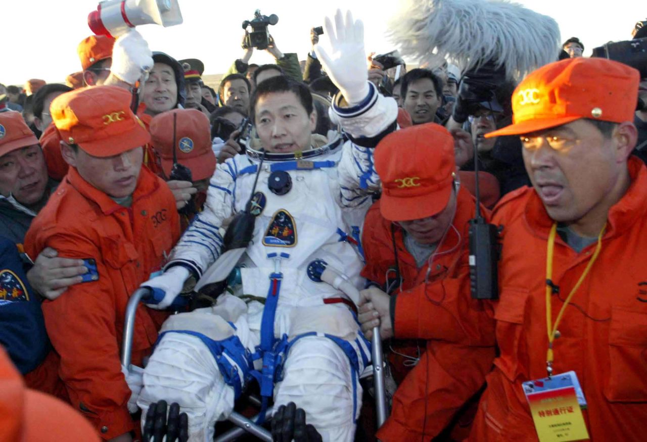Rescuers carry Yang Liwei, the first Chinese astronaut to go to space, after he landed in northern China, in October 2003. It was China's first manned space flight.