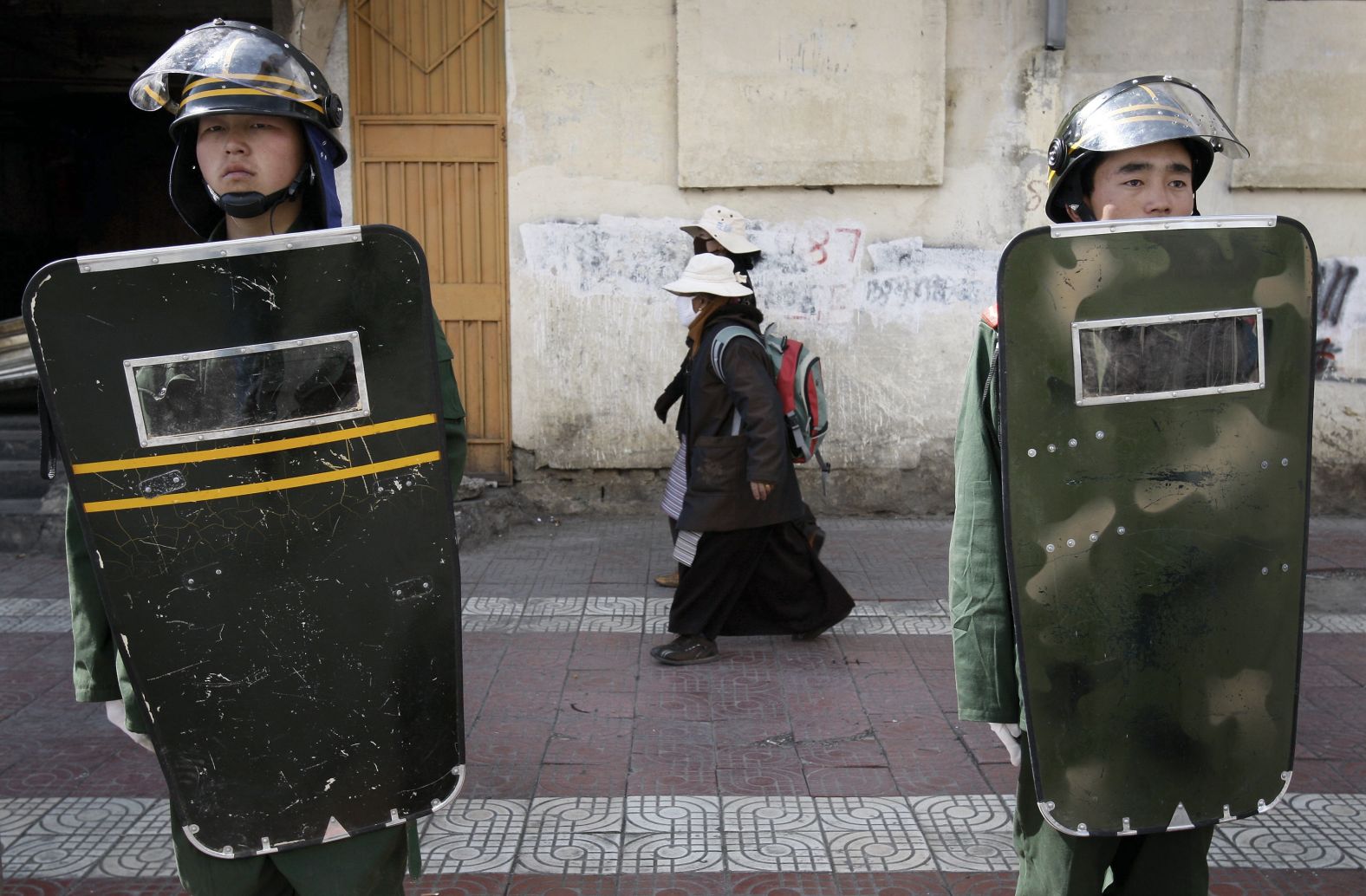 Women walk past Chinese paramilitary police in Lhasa, the capital of China's autonomous region of Tibet, in March 2008. China was <a href="https://www.cnn.com/2008/WORLD/asiapcf/11/05/china.tibet/index.htm" target="_blank">cracking down on Tibet</a> following anti-government protests and riots there.