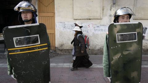 Women walk past Chinese paramilitary police in Lhasa, the capital of China's autonomous region of Tibet, in March 2008. China was <a href="https://www.cnn.com/2008/WORLD/asiapcf/11/05/china.tibet/index.htm" target="_blank">cracking down on Tibet</a> following anti-government protests and riots there.
