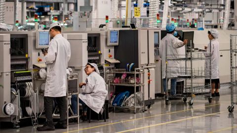 Workers are seen on the production line at Huawei's campus in Dongguan, China, in April 2019. Huawei, a Chinese company, <a href="https://www.cnn.com/interactive/2019/05/business/huawei-cnnphotos/index.html" target="_blank">is one of the giants of the tech industry</a> and the world's largest provider of telecommunications equipment.