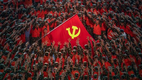 Performers surround a large Communist Party flag during a mass gala marking the party's centenary in Beijing.