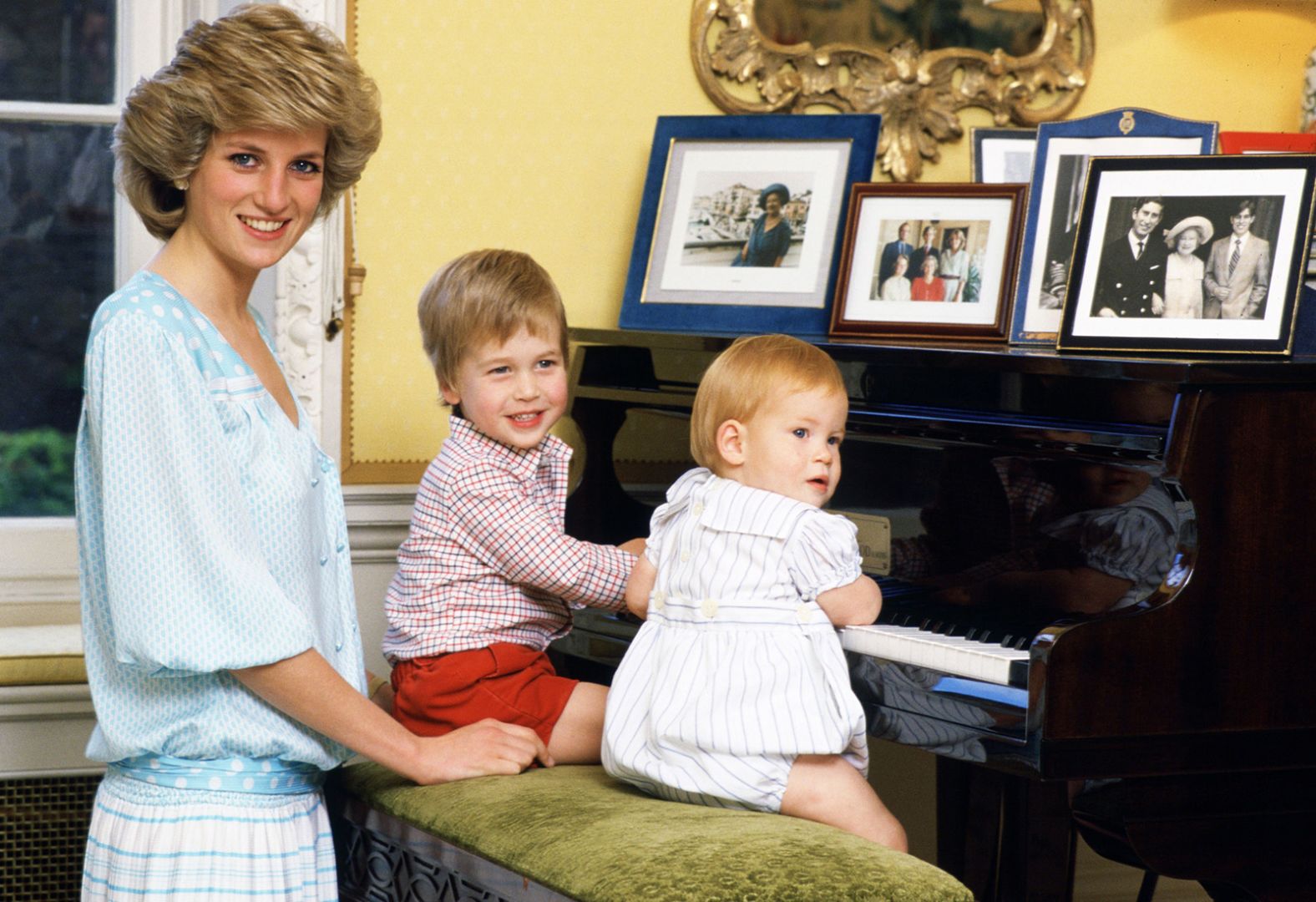 Diana poses with her boys at a piano in Kensington Palace in October 1985. 