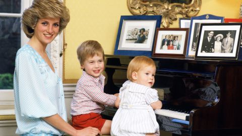 Diana poses with her boys at a piano in Kensington Palace in October 1985. 