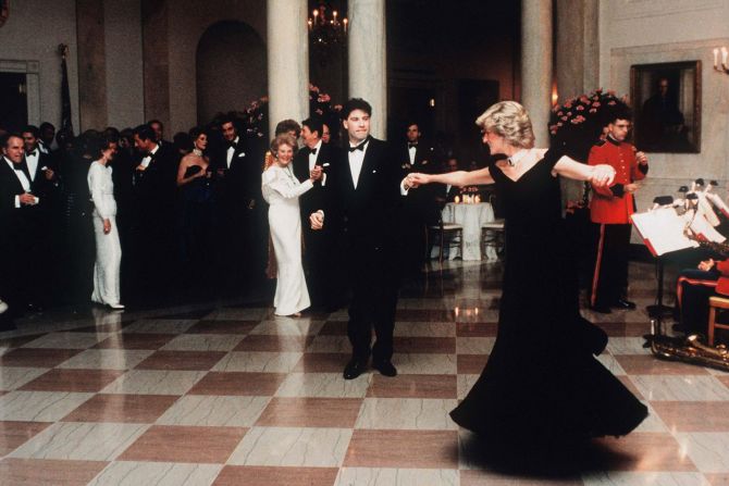 Diana dances with actor John Travolta at the White House in November 1985. Dancing behind Travolta are US President Ronald Reagan and first lady Nancy Reagan. Diana's blue velvet dress -- nicknamed the "Travolta dress" -- was auctioned in 2019 for ￡264,000 ($347,000).