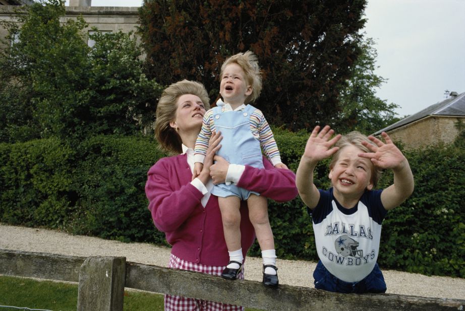 Diana holds up Harry in the garden of Highgrove House, a royal residence in Gloucestershire, England, in July 1986. 