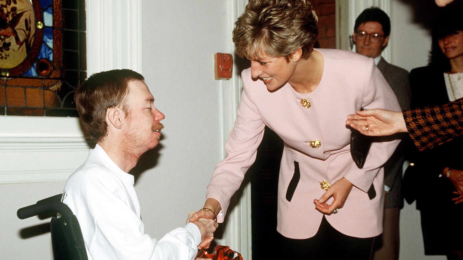 Diana shakes hands with a resident of Casey House, an AIDS Hospice, in Toronto, in October 1991. Diana's actions helped to break the stigmas associated with the virus at the time. 