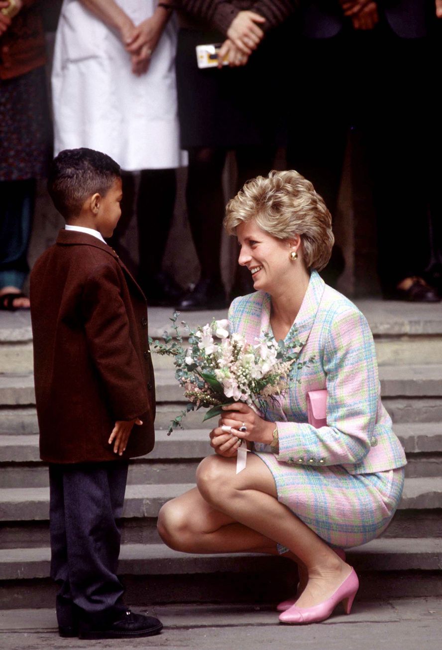 Diana crouches down to speak to a little boy outside the Great Ormond Street Hospital in London in May 1993.