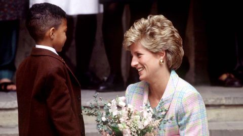 Diana crouches down to speak to a little boy outside the Great Ormond Street Hospital in London in May 1993.