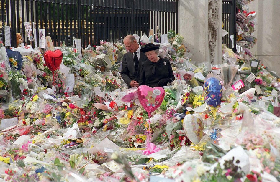 On the eve of Diana's funeral, the Queen and Prince Philip look at floral tributes left outside Buckingham Palace. More than 1 million bouquets of flowers were left at Kensington Palace, Buckingham Palace and St. James's Palace in the wake of Diana's death.