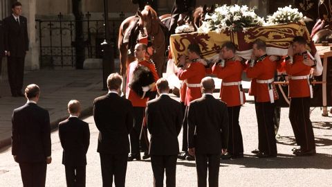 Diana's coffin is carried into London's Westminster Abbey in September 1997. Watching at the bottom, from left, is Prince Charles, Prince Harry, Charles Spencer, Prince William and Prince Philip. 