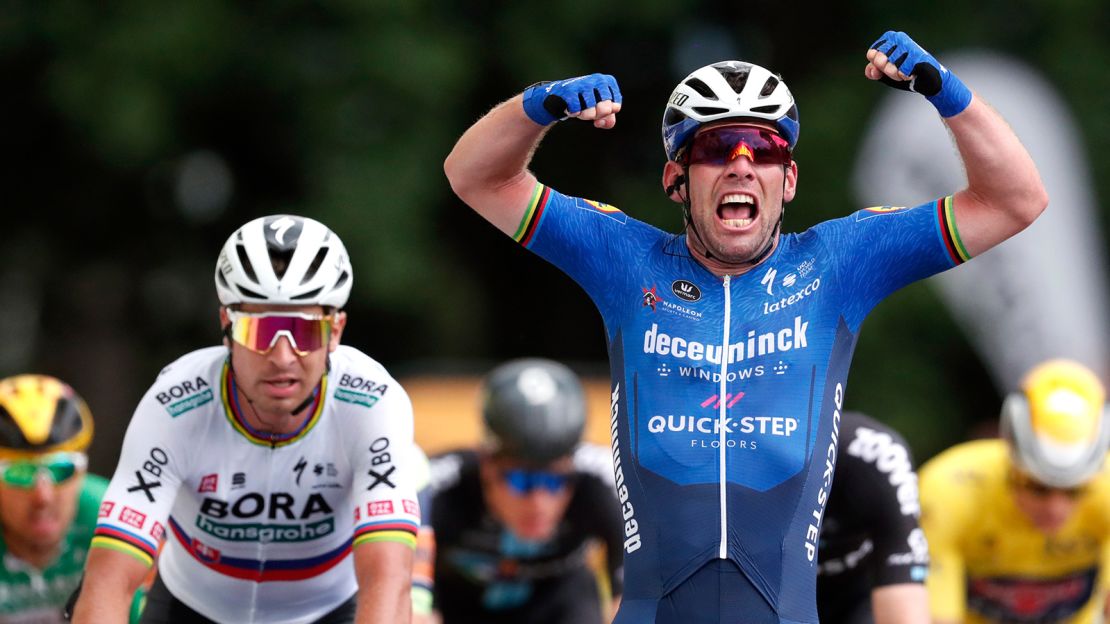 Mark Cavendish, with Solvakia's Peter Sagan on his side, crosses the finish line as he wins stage four.
