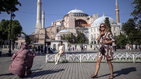 Tourists take pictures in front of the Hagia Sophia Mosque in Istanbul, Turkey on 27 June 2021. The reduction in tourism could cause unemployment to rise by as much as 10%, according to UNCTAD.