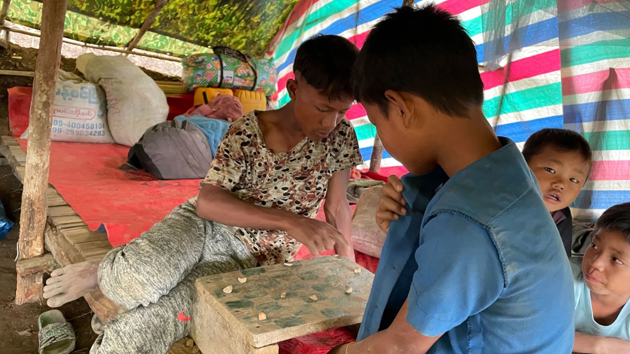 Refugee children from Chin State villages emptied for fear of a Myanmar Army attack pass time playing homemade checkers.