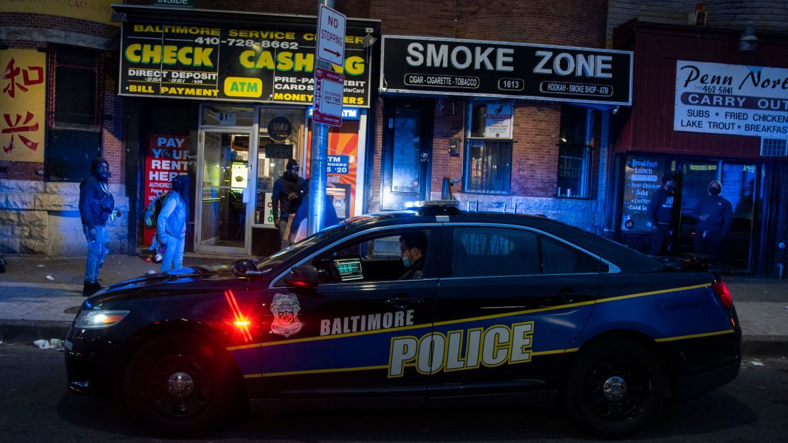 A Baltimore police officer patrols Friday, April 17, 2020, in the area of unrest after Freddie Gray, who lived nearby, was arrested more than five years ago.