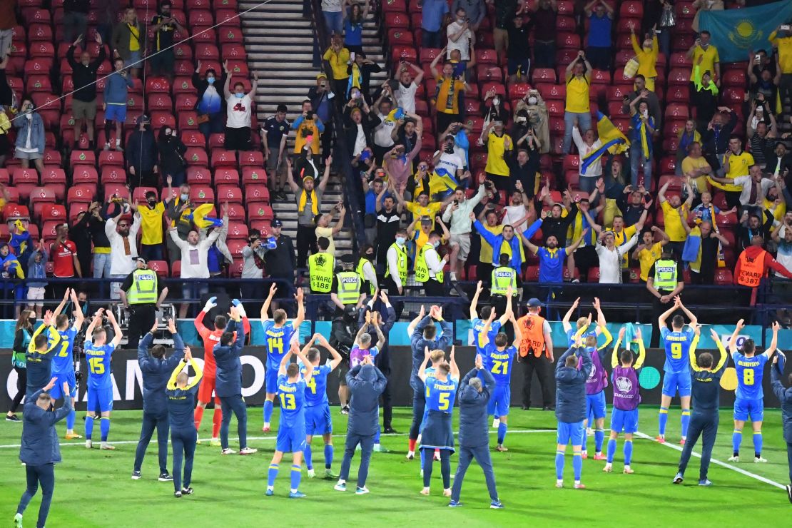 Ukraine's players celebrate with supporters after beating Sweden.