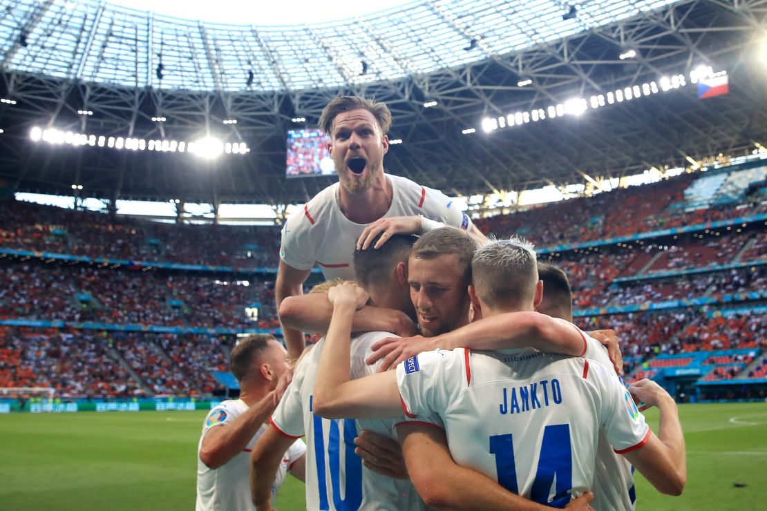 Patrik Schick is mobbed by his teammates after scoring against the Netherlands.