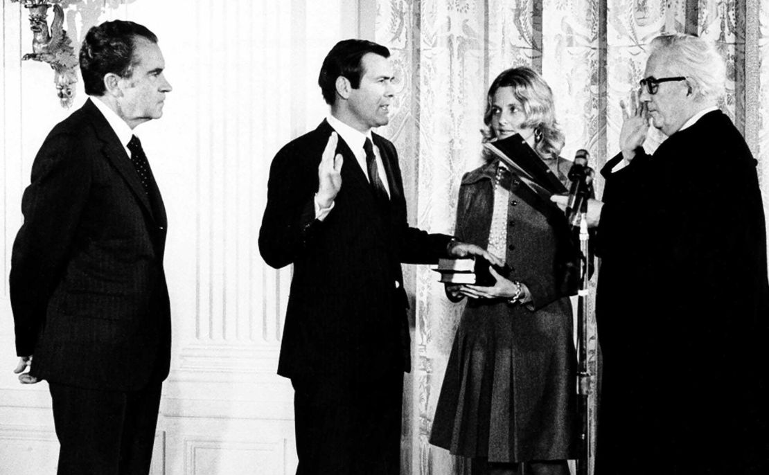 Donald Rumsfeld, second from right, new United Nations ambassador to the North Atlantic Treaty Organization, takes oath of office from Chief Justice Warren E. Burger, right, during a ceremony on February 2,1973, at the White House. President Richard M. Nixon looks on at left and Mrs. Joyce Rumsfeld holds a Bible  for her husband.