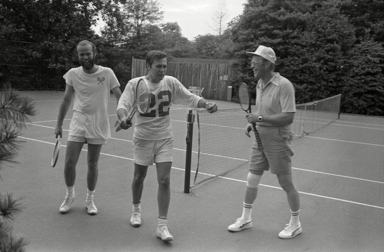 Rumsfeld, center, plays tennis at the White House with President Ford, right, and chief White House photographer David Hume Kennerly in 1975.