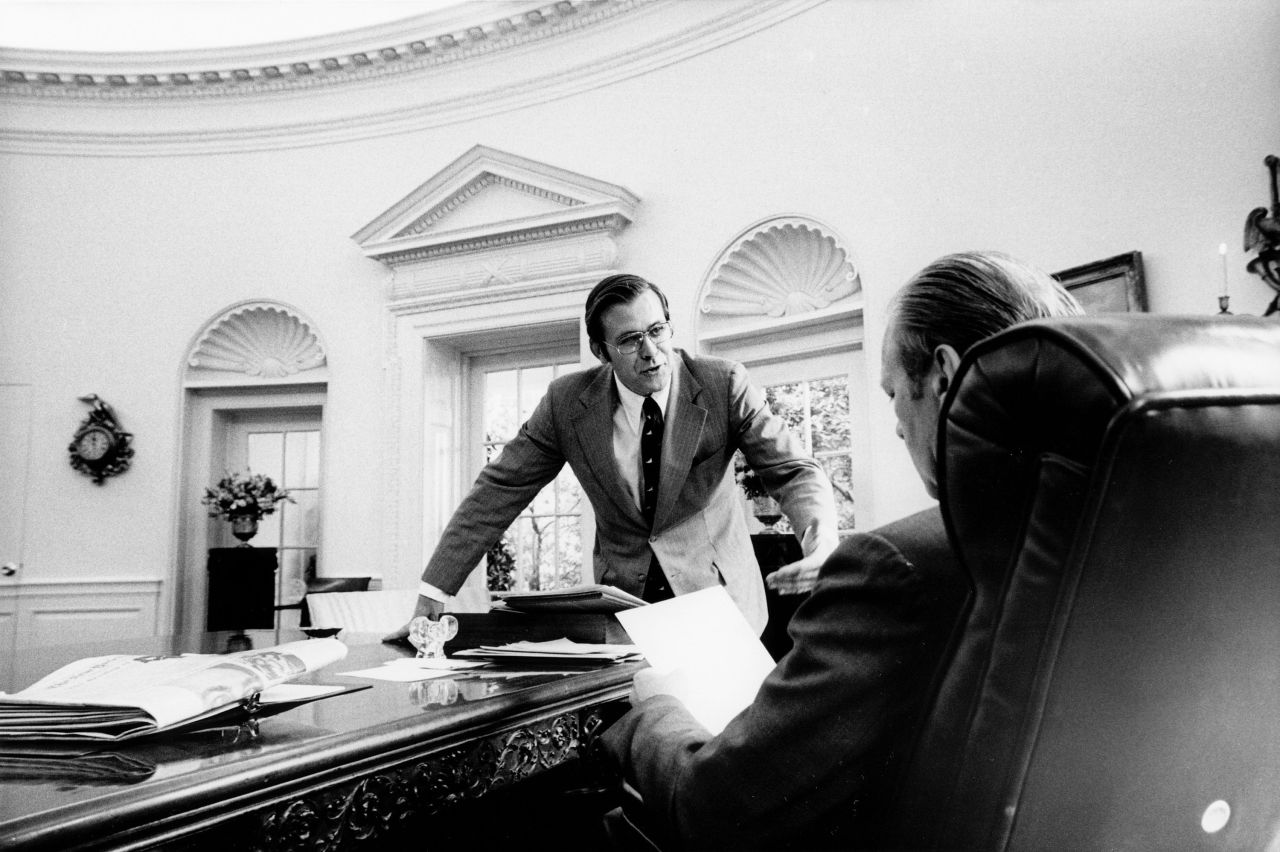 Rumsfeld speaks with Ford in the Oval Office circa 1975.