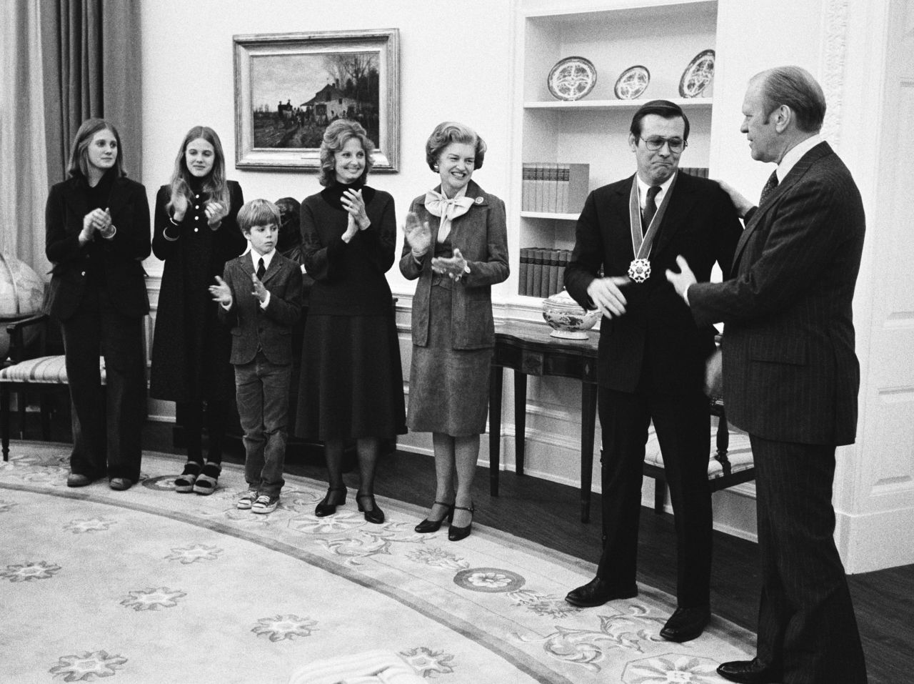 Rumsfeld receives the Presidential Medal of Freedom from Ford in January 1976. Joining them, from left, are Rumsfeld's children, Valerie, Marcy, and Nick; his wife, Joyce; and first lady Betty Ford.