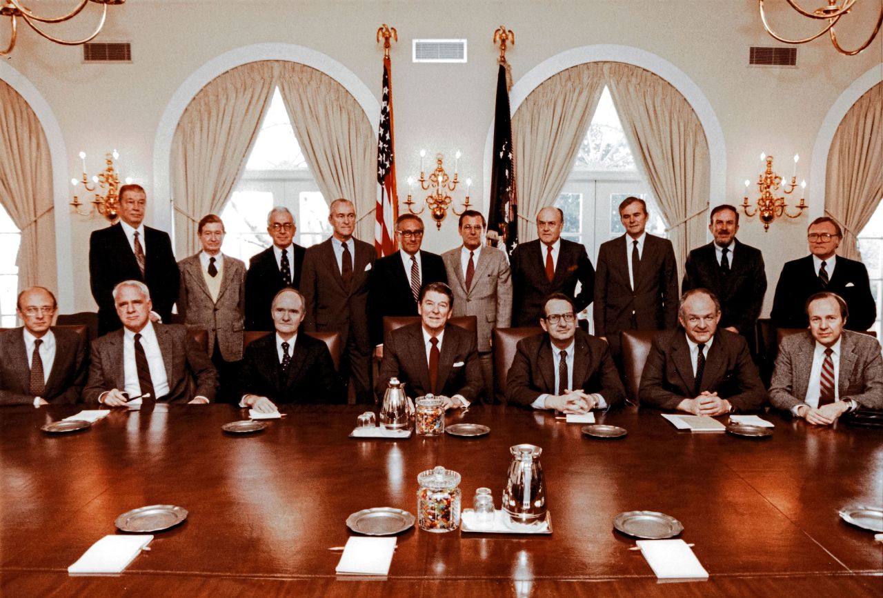 Rumsfeld, standing at center in the light-gray suit, poses with President Ronald Reagan, the President's Commission on Strategic Forces and the special counselors to the commission in 1983.