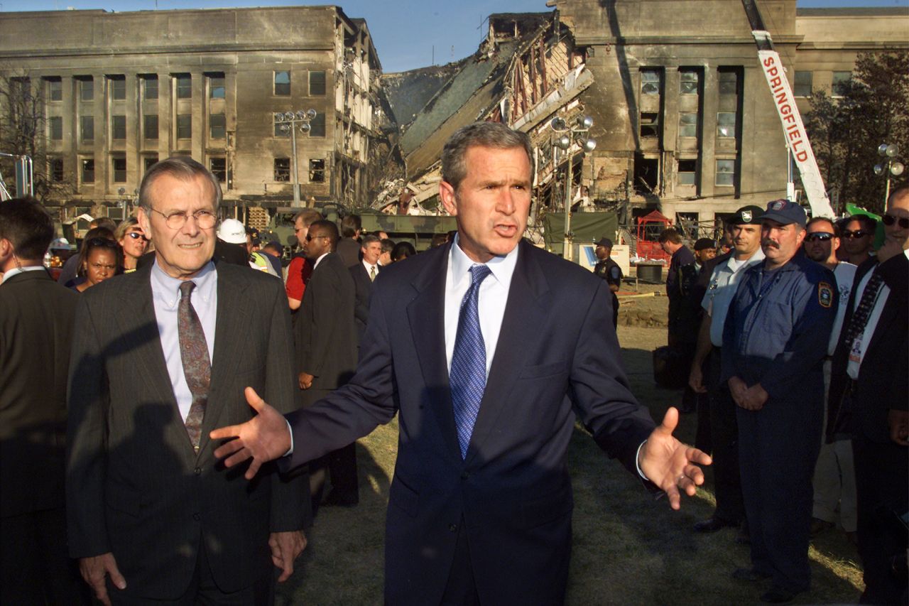Rumsfeld, left, joins Bush as they visit the Pentagon following the terrorist attacks on September 11, 2001.
