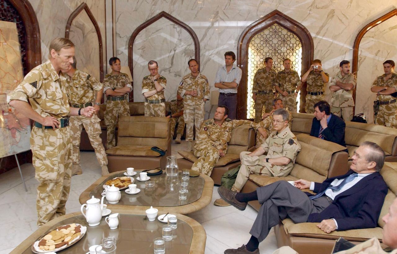 Rumsfeld is briefed by British Major Gen. Robin Brimms, left, at the Basra Airport in Iraq in April 2003.