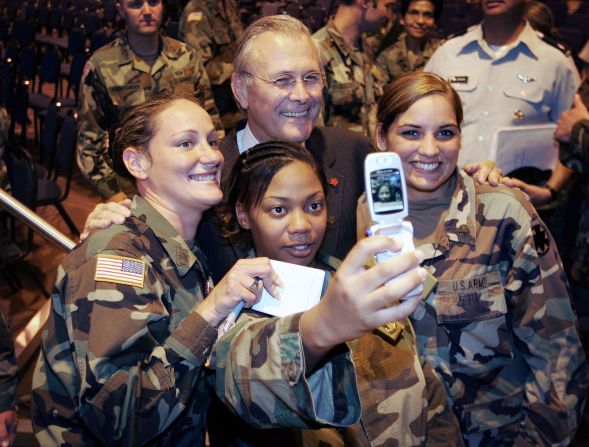 Rumsfeld poses for a photo with US troops during a visit to California's Fort Irwin in August 2005.