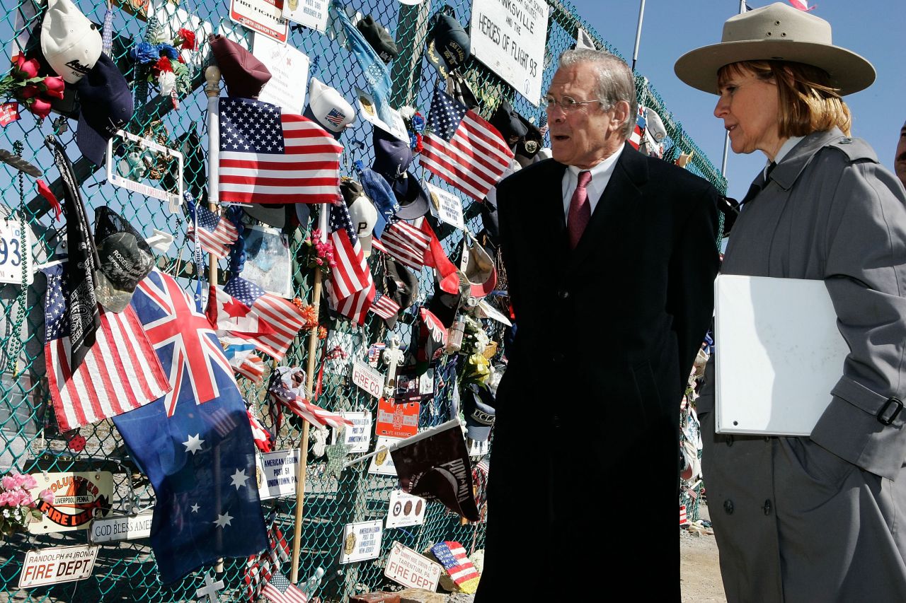 Rumsfeld is escorted by Joanna Hanley, superintendent of the Flight 93 Memorial, as he looks at tributes in Shanksville, Pennsylvania, in March 2006.