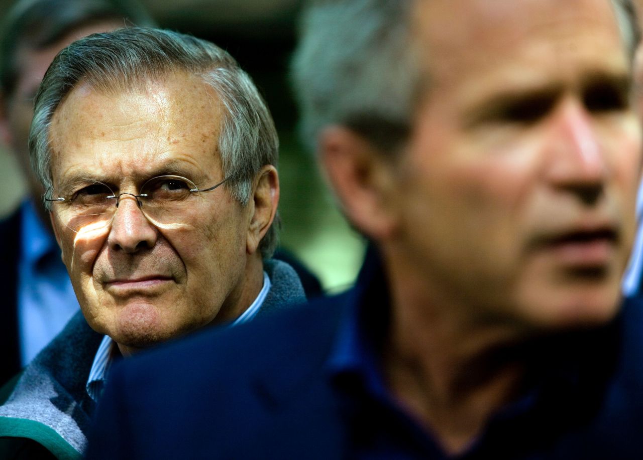 Rumsfeld listens as Bush speaks to reporters at Camp David, the presidential retreat in Maryland, in June 2006.