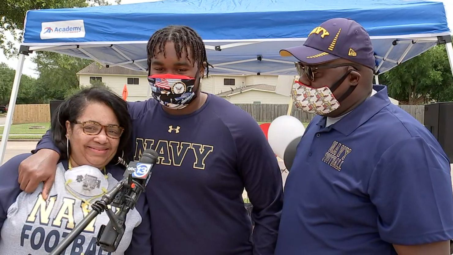 Michelle Cummings and her husband, Leonard, celebrate in May 2020 after their son Leonard Cummings III, center, committed to play football at the US Naval Academy.