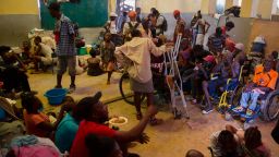 A group of blind and disabled people eat at a refuge for displaced persons after armed gangs set their homes on fire in Port au Prince, Haiti, Thursday, June 24, 2021. (AP Photo/Joseph Odelyn)