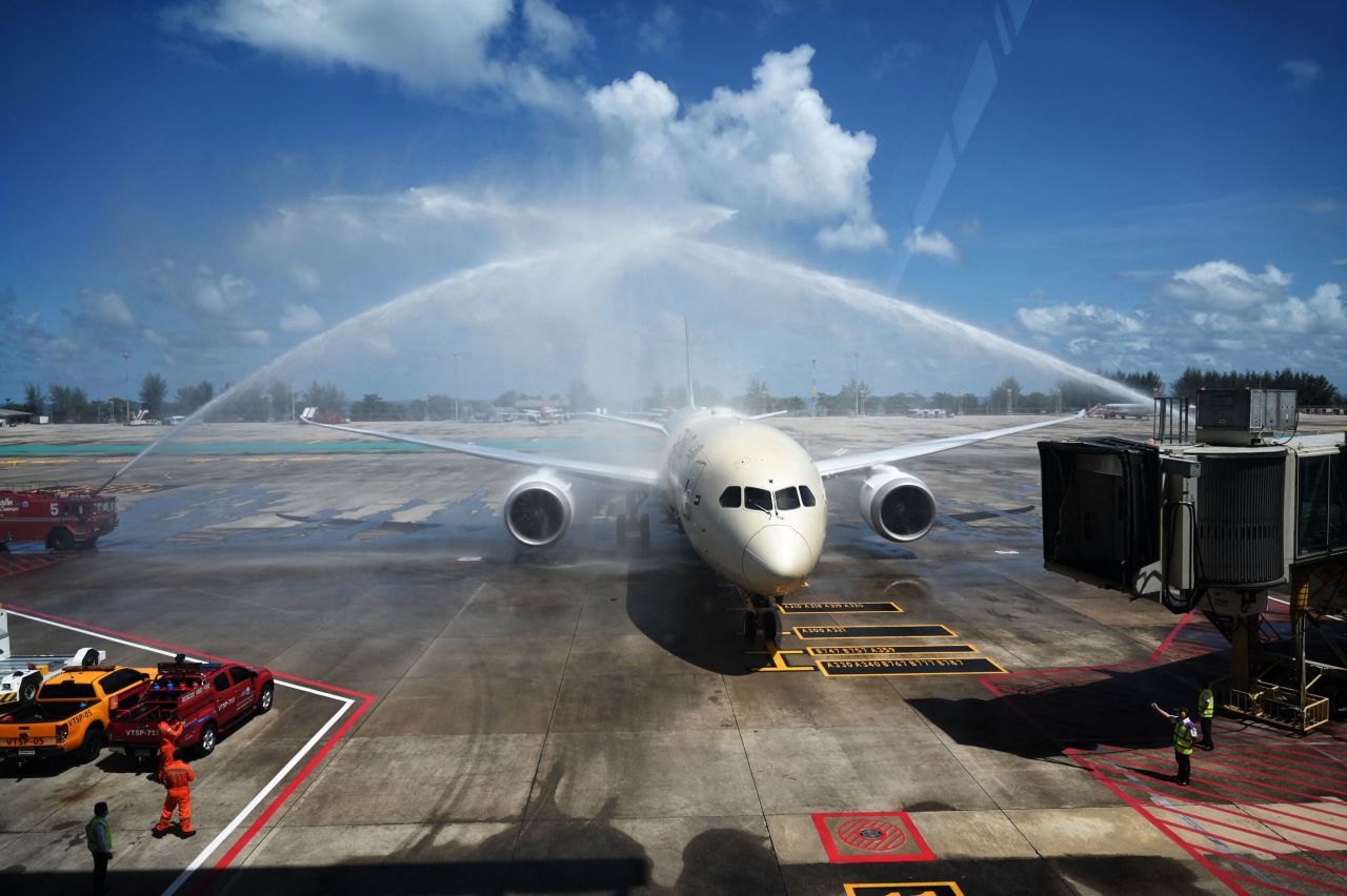 Celebratory sprays of water are splashed over an Etihad Airways airplane arriving from Abu Dhabi at Phuket International Airport on July 1, 2021. 