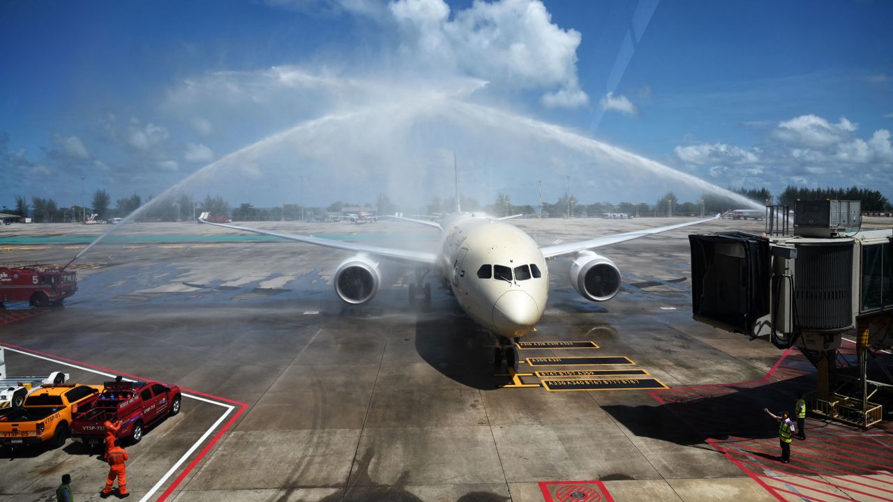 Celebratory sprays of water are splashed over an Etihad Airways airplane arriving from Abu Dhabi at Phuket International Airport on July 1, 2021. 