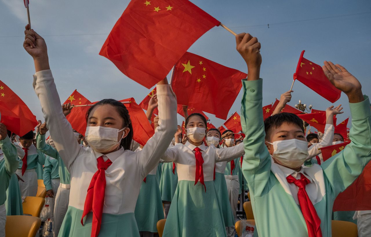 Students wave flags at the 100th anniversary celebration in July 2021.